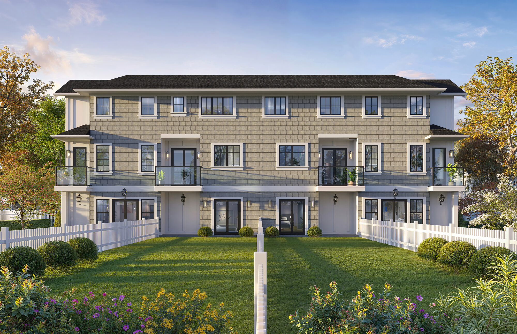 Rear exterior rendering of Magnolia townhomes showing private balconies and a landscaped lawn courtyard